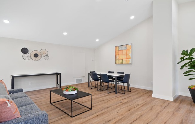 a living room with a couch and a table with chairs