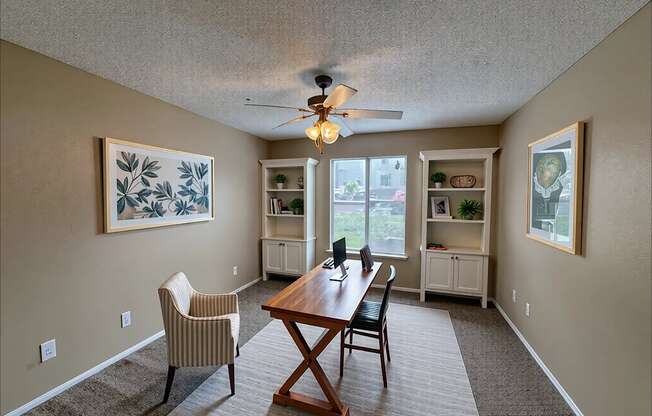 A dining room with a wooden table and chairs.