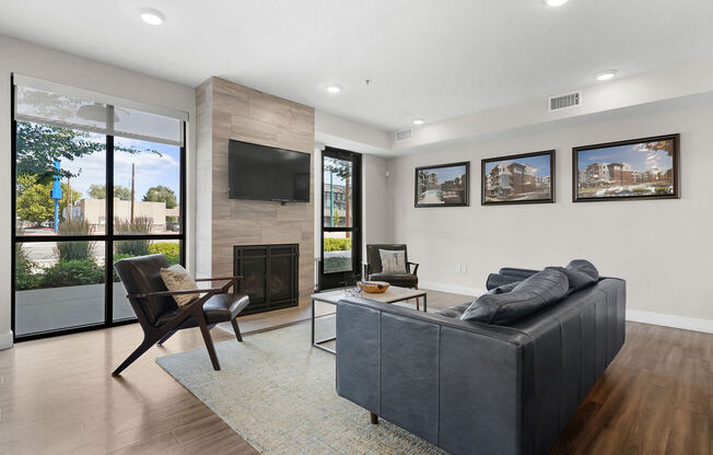 the living room has a fireplace and a leather couch