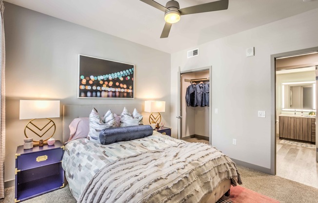 bedroom with ceiling fan bed and night stands at arte apartments