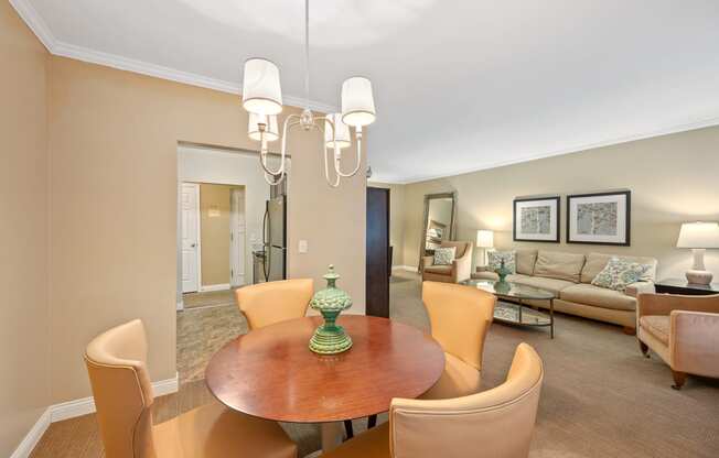 a living room and dining room with a table and chairs