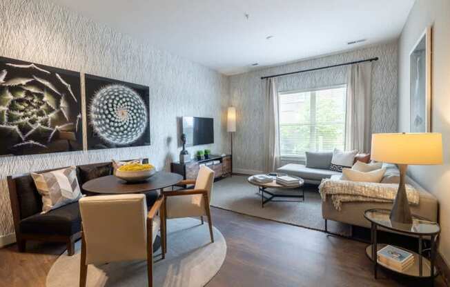 A modern living room with a dining table and chairs.