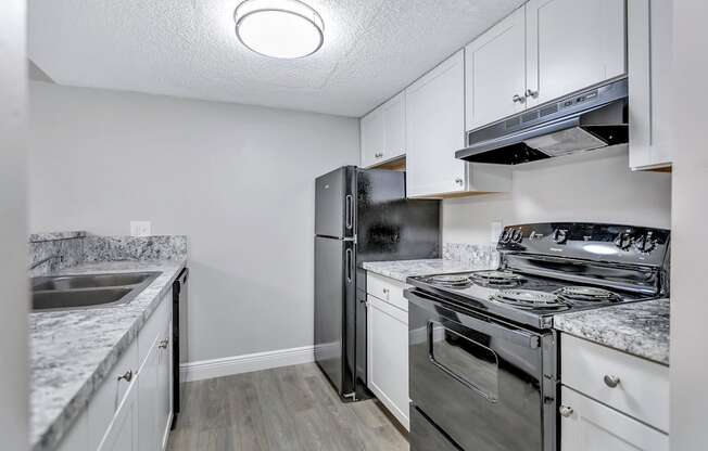 a kitchen with stainless steel appliances and white cabinets