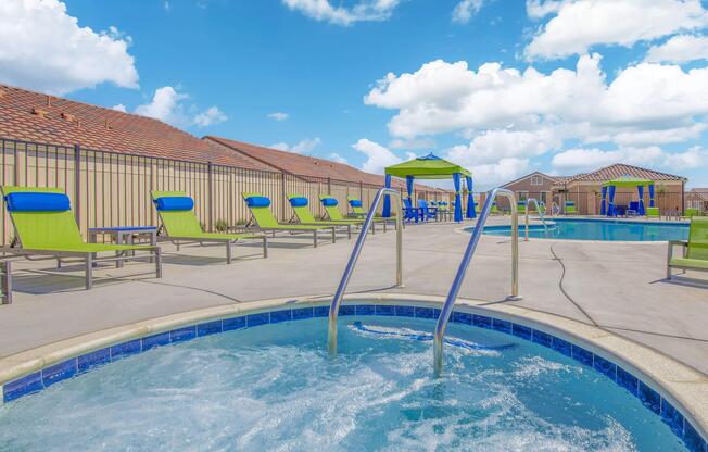 a sandy beach next to a swimming pool