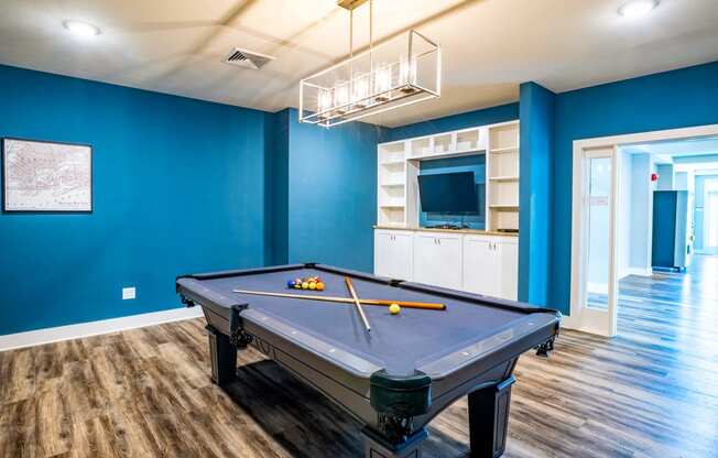 Room with blue walls and a pool table at Trillium apartments in Melbourne fl