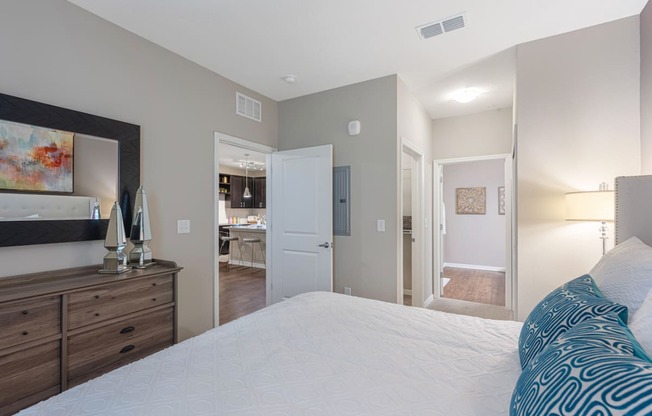 a bedroom with a large bed and a mirror