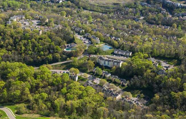 an aerial view of a neighborhood of houses and trees