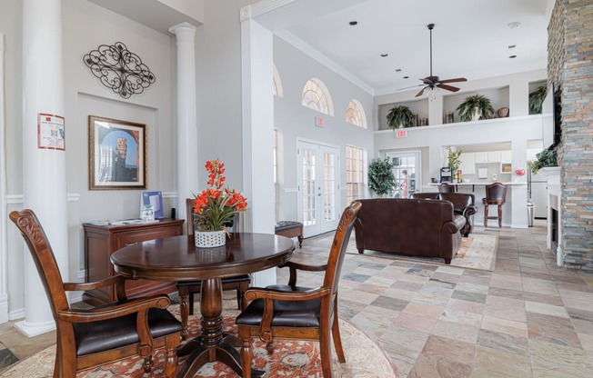 a living room and dining room with a table and chairs