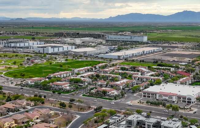 an aerial view of a city with buildings and cars