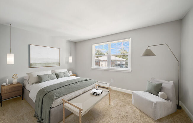 a bedroom with gray walls and a large window