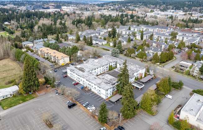 an aerial view of a building in a parking lot