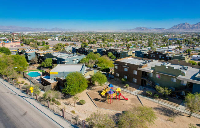 an aerial view of a neighborhood with a playground and houses