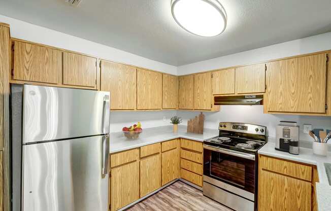 a kitchen with wooden cabinets and stainless steel appliances