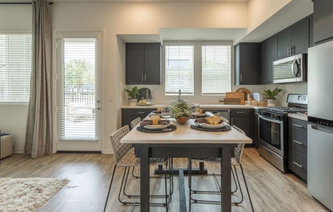 an open kitchen and dining room with a table and chairs