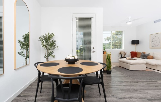A modern dining room with a round table and chairs.