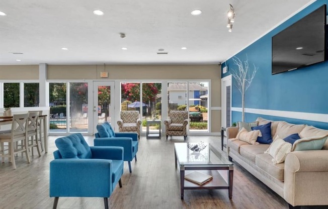 a living room with couches and chairs and a television