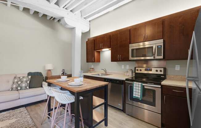 a kitchen with wooden cabinets and stainless steel appliances