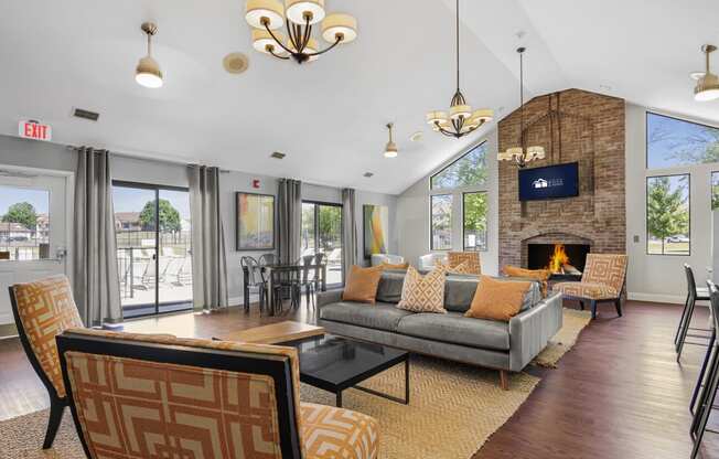 a living room with a couch and chairs and a fireplace