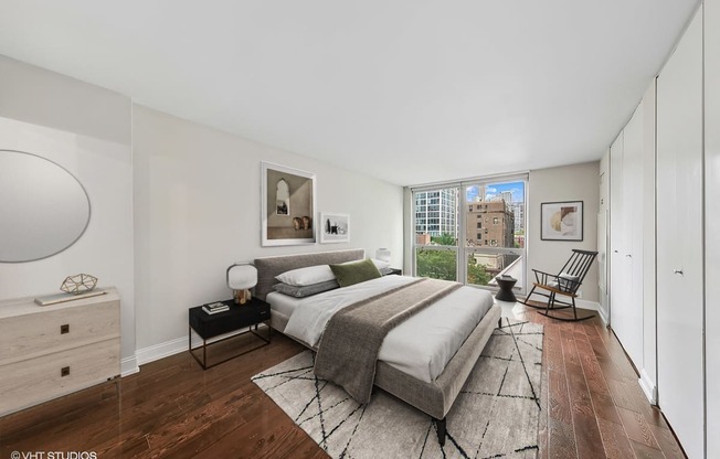 a bedroom with a bed and a large window