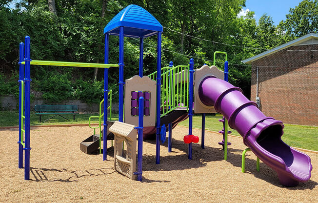 a playground with a slide at apartment complex