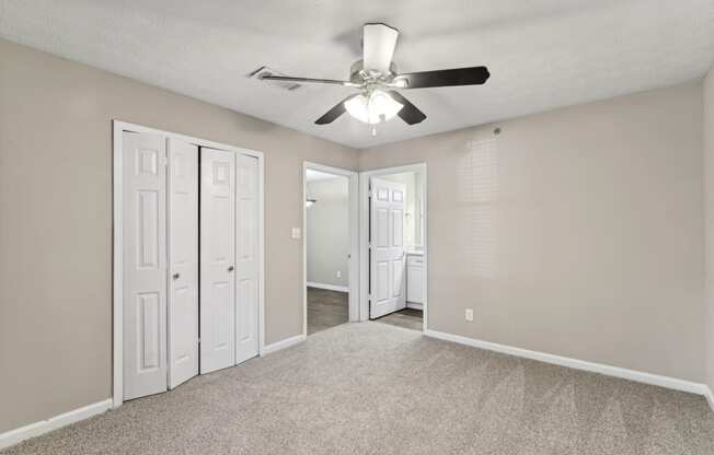 Unfurnished bedroom with closet and ceiling fan at Oakley Run apartments in Smyrna, GA