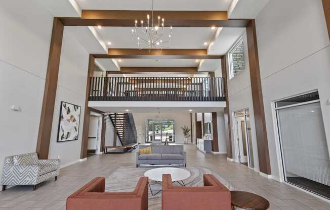 a lobby with couches and chairs and a chandelier