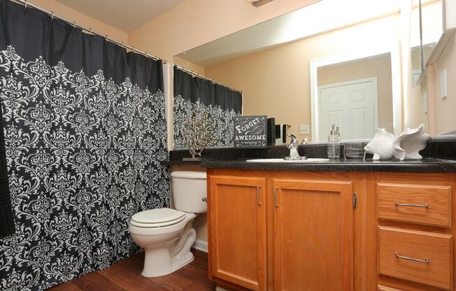 a bathroom with a black and white shower curtain
