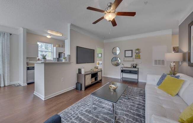 A modern living room with a white couch and a black and white coffee table.