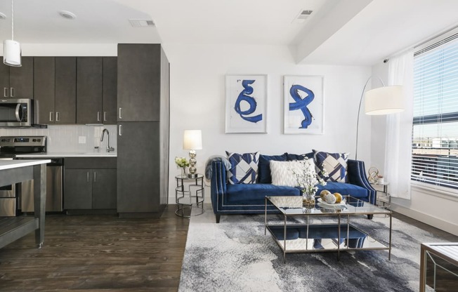 a living room with a blue couch and a coffee table