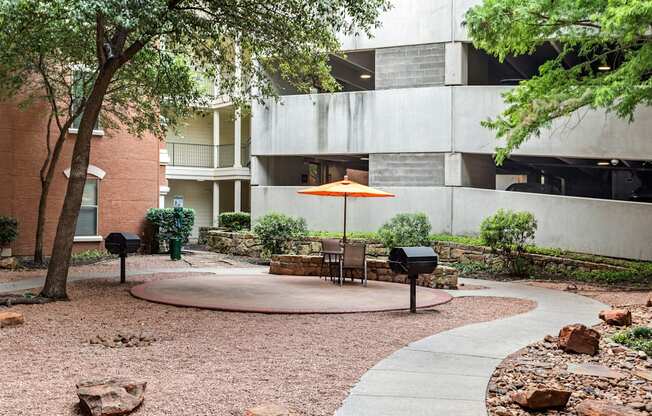 A courtyard with a table and chairs and a mailbox.