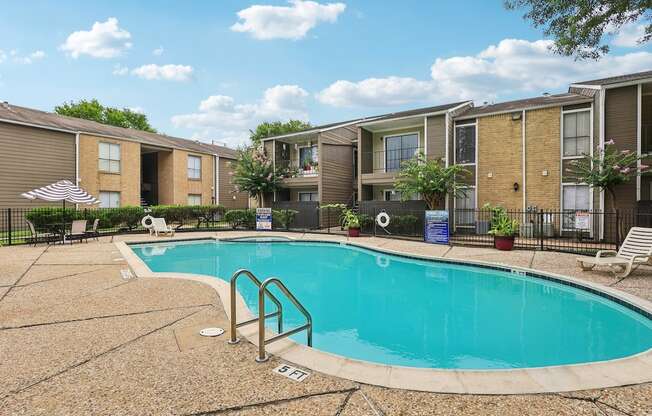 A swimming pool surrounded by apartment buildings.