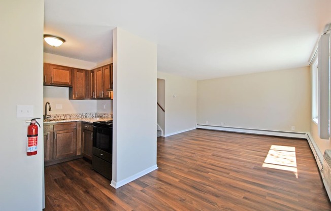 a renovated living room and kitchen with wood flooring