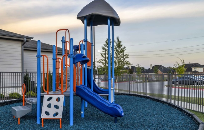 a playground with a swing set and slides