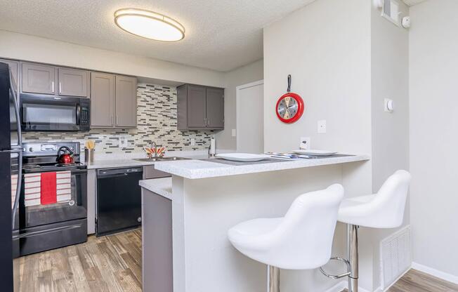 a kitchen with a sink and a mirror