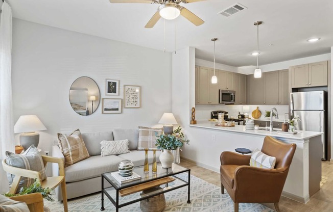 a living room and kitchen with a couch and a table