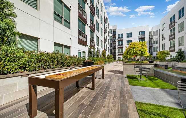 Outdoor shuffleboard table on a landscaped terrace designed for relaxed afternoons and social fun