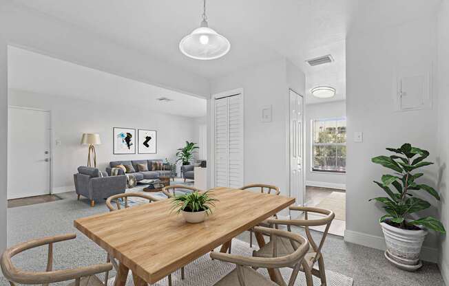 A dining room with a wooden table and chairs.