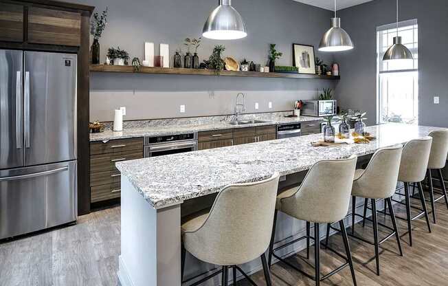 A kitchen with a marble countertop and modern appliances.