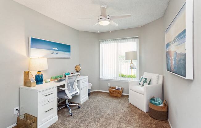 an office with a desk and a chair and a window