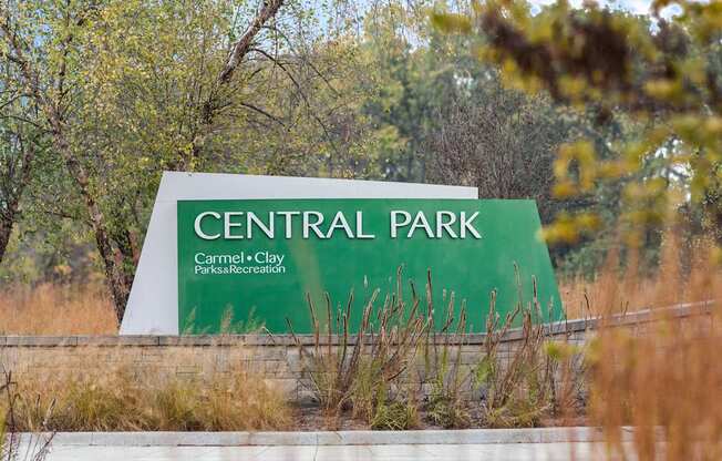 the sign for central park at the entrance of the park