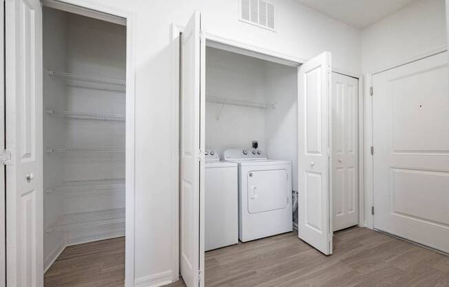 A white laundry room with a washer and dryer.