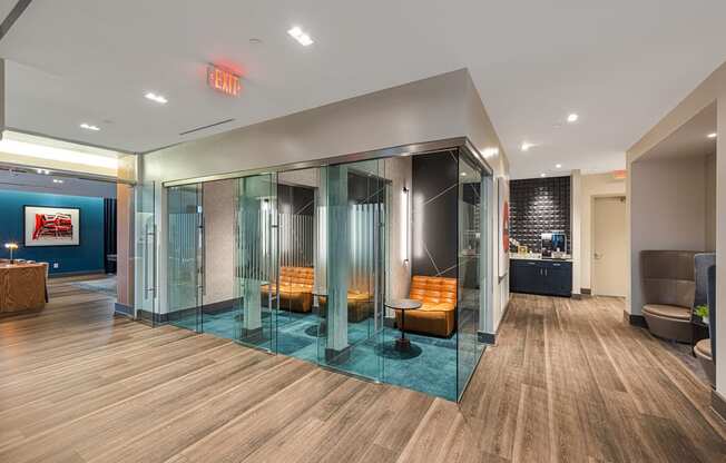 a large lobby with glass walls and furniture