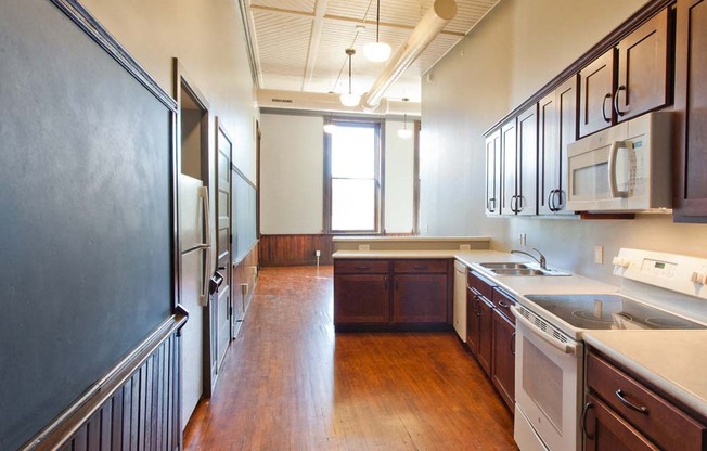 The kitchen in this one bedroom apartment has chalkboards that are original to the building.