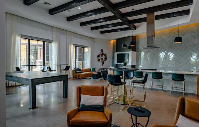 A modern dining room with a long table and chairs.
