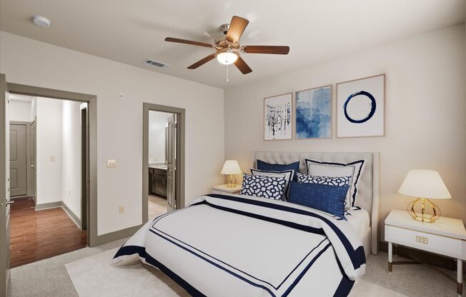 a bedroom with a large bed and a ceiling fan