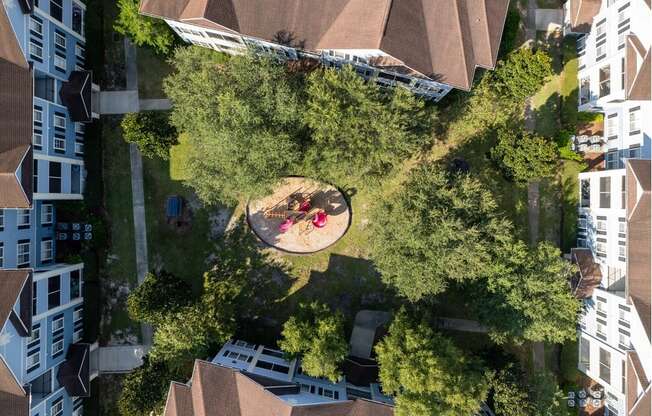 a birdseye view of a park with people sitting on the grass