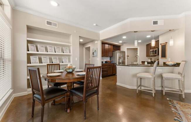 A dining room with a table set for four. at Bridge at Heritage Woods, Austin, 78753