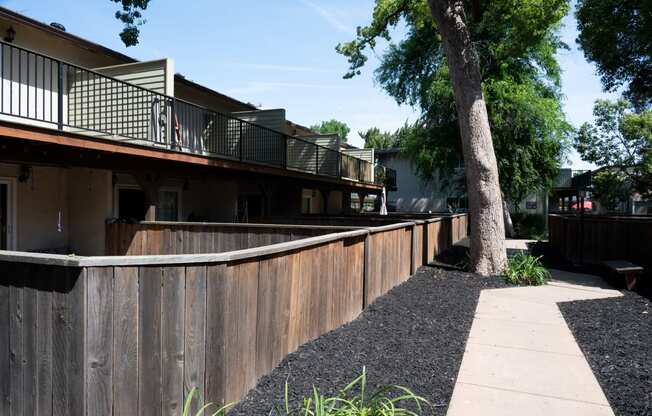 View of private patio/balcony and sidewalk winding through