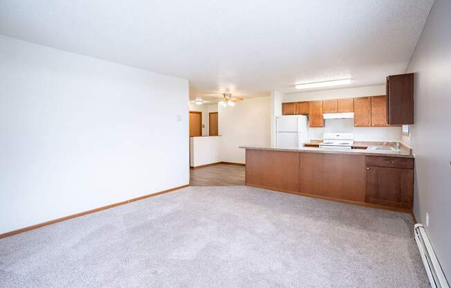 A kitchen area with a counter and cabinets. Fargo, ND Westwood Estates