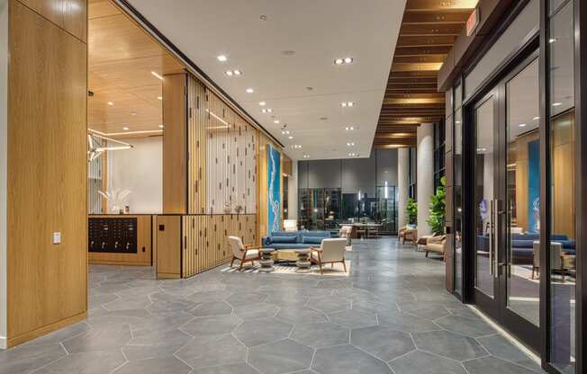 a large lobby with furniture and glass doors